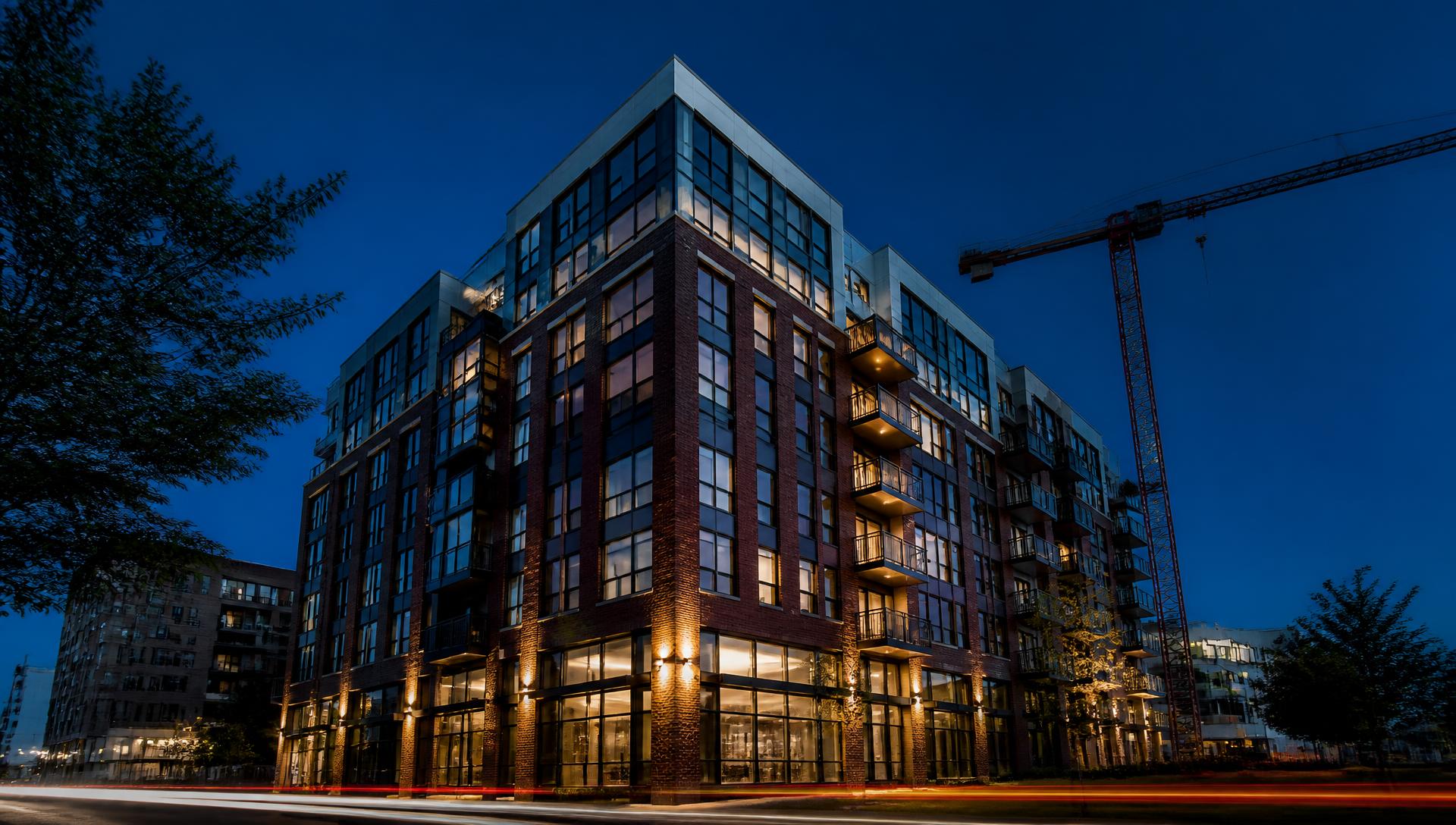 Modern mixed-use building under construction at blue hour